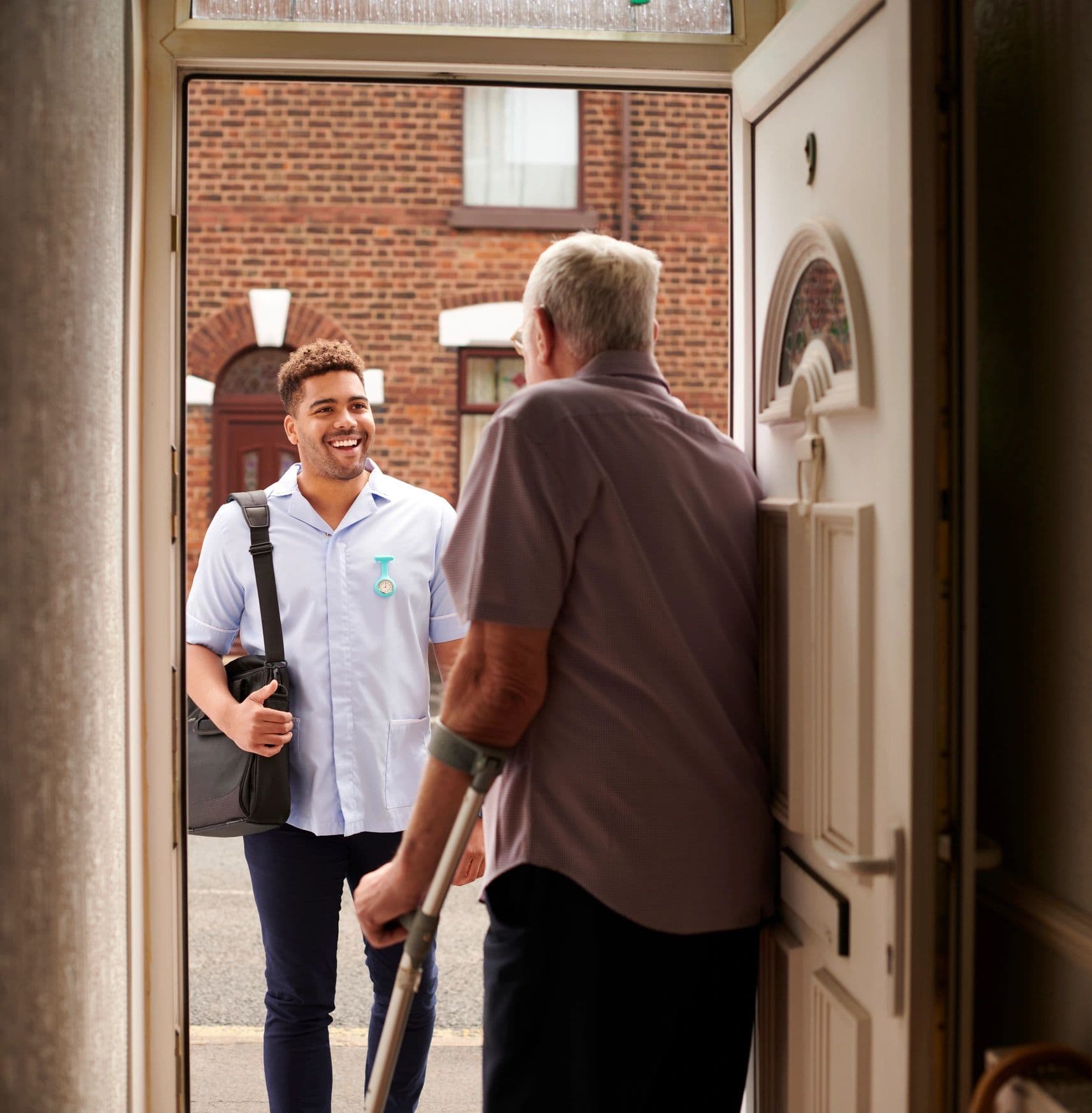 Caregiver arriving at an older man’s front door